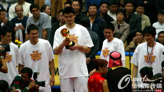 2003年哈爾濱亞錦賽，中國男籃獲得冠軍。圖片背景：2003年10月1，2003年男籃亞錦賽決賽，中國106：96勝韓國。中國隊上台領獎姚明接過冠軍獎杯