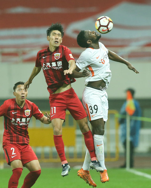 11月7日，北京人和隊球員迪奧普（上右）與上海上港隊球員呂文君在比賽中爭頂。新華社記者丁汀攝